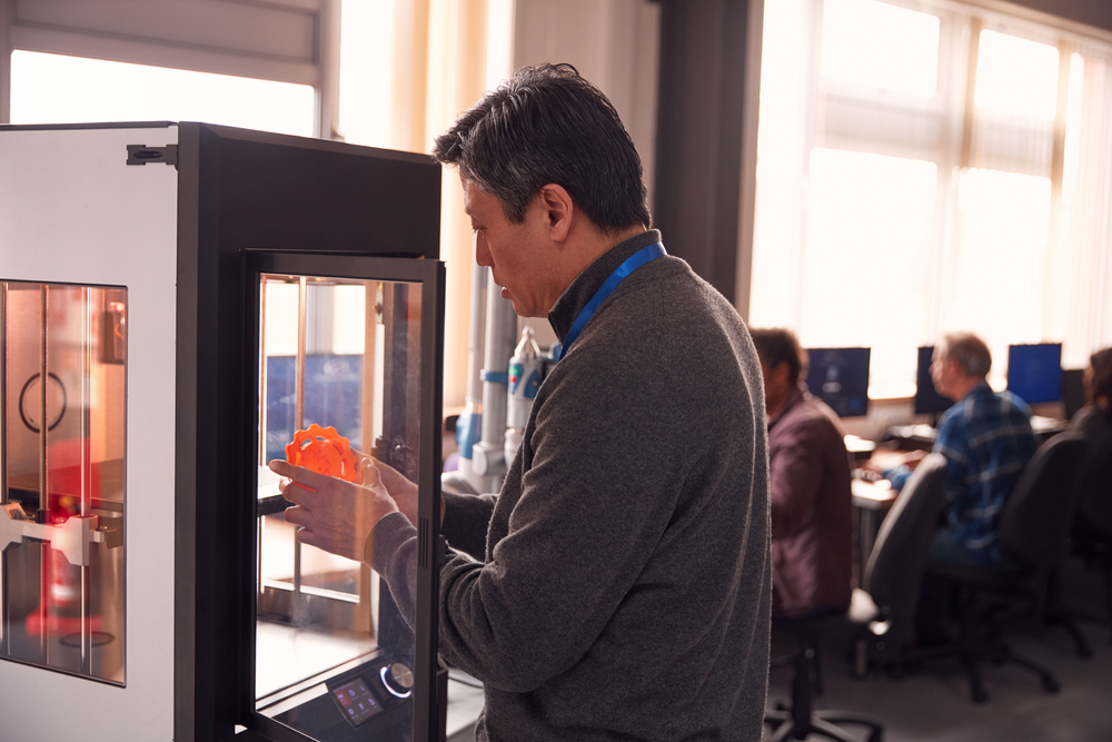 Male Employee Looking at 3D Printed Part